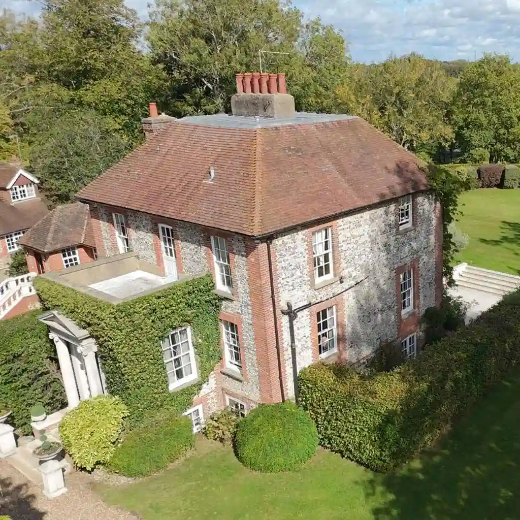 Drone capturing roof and chimney details during a modern property survey inspection